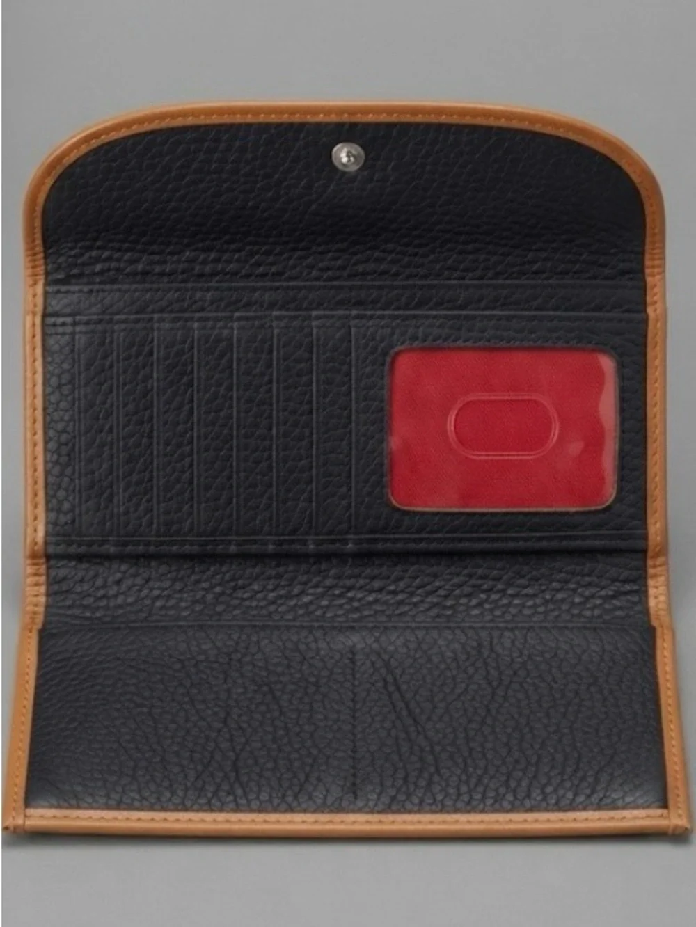 3 1/2”. X. 7”.  pebble-grain leather Dooney & Bourke Continental Clutch